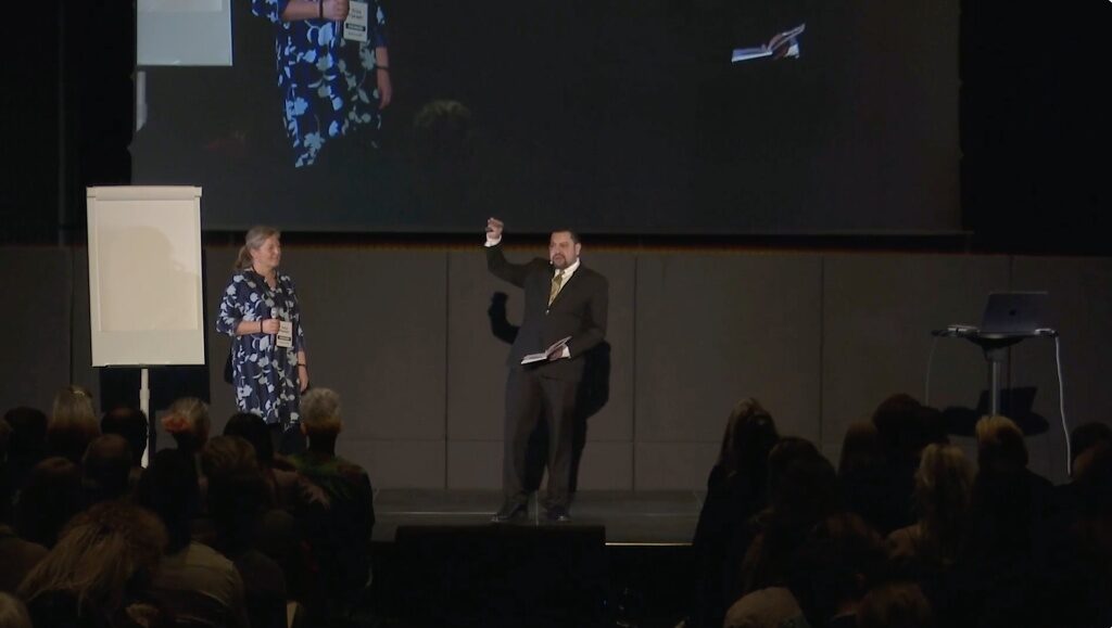 Mohammed Ali presenting the C.O.A.C.H.E.S. Curve on stage